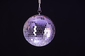 One shiny disco ball on black background