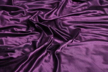 Luxury purple silk bed linens as background, closeup