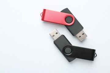 Flash drives on white background, flat lay