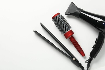 Different hairstyling tools on white background, flat lay. Space for text