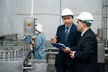 A businessman discussing with business partner at fish factory. Entrepreneur inspecting quality...