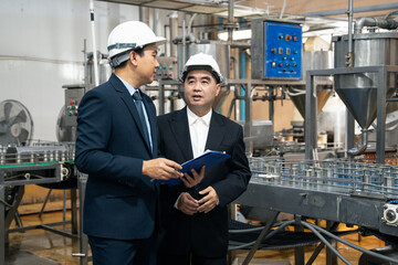 A businessman discussing with business partner at fish factory. Entrepreneur inspecting quality...