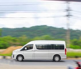 A white van is speeding on the road.