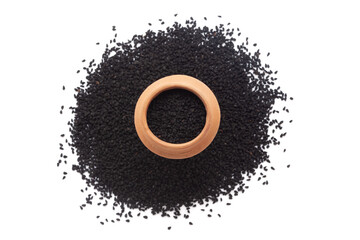 A mud pot filled with organic Black Cumin (Nigella sativa) or kalonji is placed on a heap of nigella seeds, isolated on a white background.
