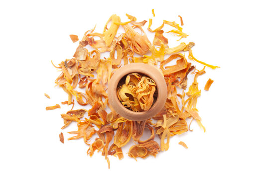 A mud pot filled with organic Mace (Myristica fragrans) or javitri is placed on a heap of Mace, isolated on a white background.