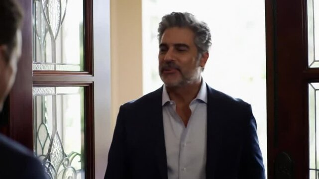 Businessman Enters Modern Office and Is Warmly Welcomed &ndash; Corporate Arrival and Professional Greeting Concept

