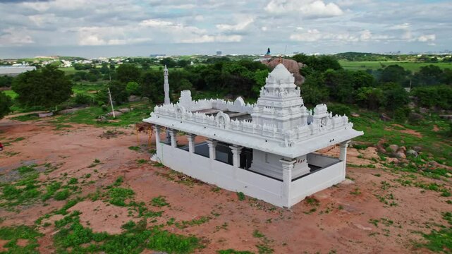 Temple back side with greenery, sky and clouds at day time, semi orbit, drone shot, 4k.