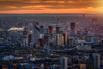 Elevated view of the London skyline with Elephant and Castle and Chelsea district in the background during sunset time © moofushi