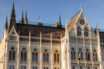 Detailed exterior views of the Hungarian Parliament Building in Budapest showcasing neo-Gothic architecture, pointed spires, arches, and ornate stonework