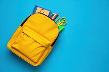 Naklejka premium Vibrant Yellow Backpack Filled with School Supplies for a Fresh Start