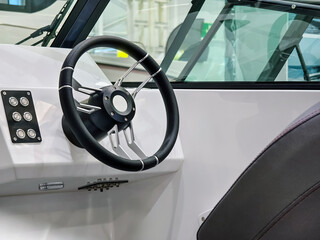 Modern boat steering console showcasing advanced controls and sleek design in a marine setting