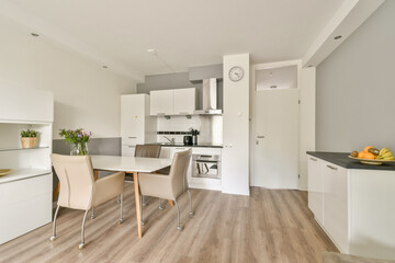 Contemporary kitchen with stylish furniture, sleek cabinetry, and a bright, open layout, perfect for cooking and dining. A space that blends functionality and aesthetics.