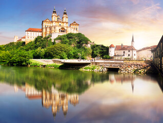 Obraz premium Melk Abbey at dramatic sunrise with reflection in water, Wachau - Lower Austria
