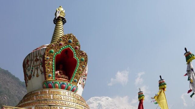 Chhomrong Gumba Stupa decorated with colorful prayer flags in Annapurna Base Camp trek, Nepal.