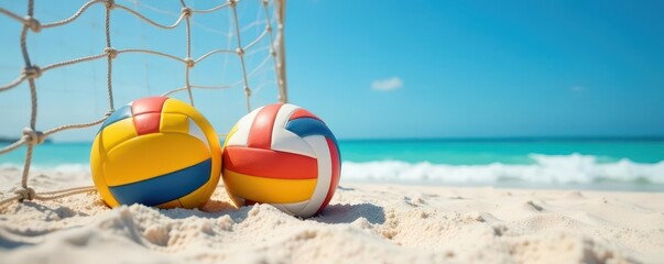 Obraz premium Two volleyballs on beach sand near net, blue sky, horizon, morning, landscape