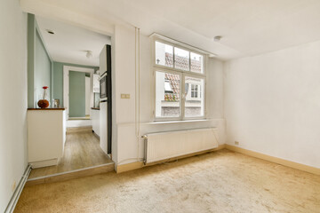 A bright, minimalist interior showcasing a cozy room with a soft carpet and natural light streaming through a window, accentuated by modern decor elements.