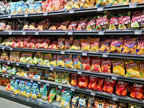 Kiel, Germany - 19. April 2025: Full shelves displaying potato chips bags in a supermarket