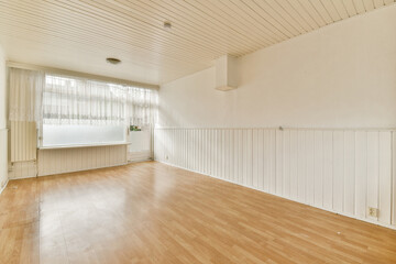 A spacious and minimal interior showcasing wooden floors and white walls, ideal for various designs or renovations in modern living spaces.