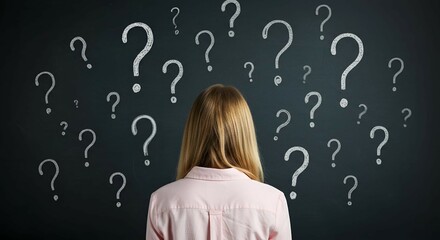 a thoughtful young European girl with chalk-drawn question marks on blackboard background. Solution, education and knowledge concept.