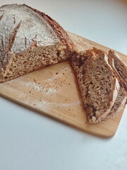 freshly cut artisanal sourdough bread showing crumb and texture on a rustic wooden surface on white table