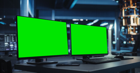 Office Desk with Two Computer Displays in an Empty Technology Office Without People. Green Screen...