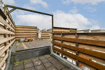 A well-designed outdoor area featuring wooden fencing and a spacious layout. Ideal for relaxation and gatherings, with a touch of modernity.