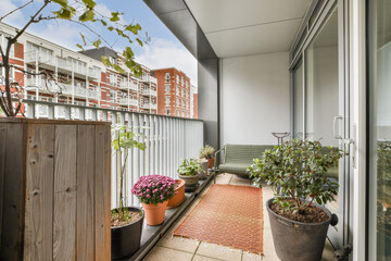 A charming balcony featuring an arrangement of potted plants, providing a serene outdoor space. Ideal for relaxation and enjoying nature in an urban setting.
