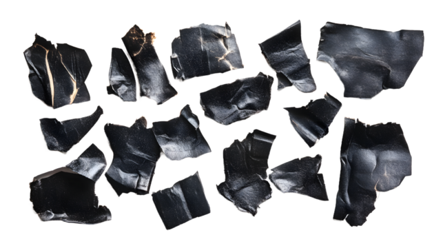 A collection of irregularly shaped black fragments against a white background, showcasing texture and contrast.