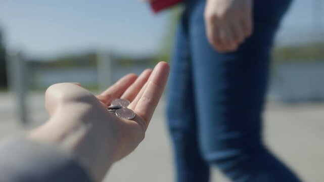 Giving spare change to a homeless person as a small act of kindness