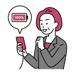 スマートフォンを充電する中年のスーツの女性