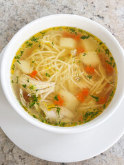 Homemade Chicken Noodle Soup with Vegetables in White Bowl