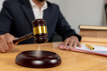 Concept of law and justice, a judge's gavel and legal books placed on a wooden desk