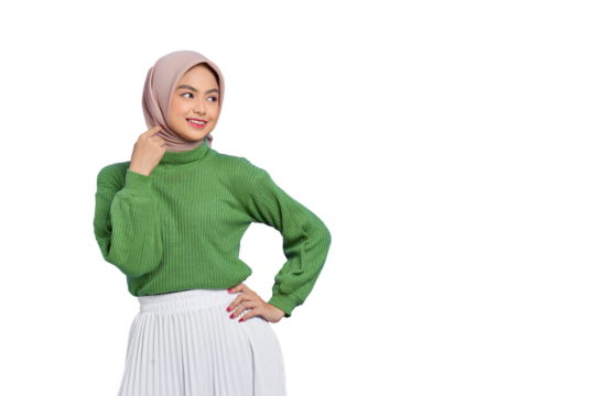 Beautiful smiling Asian woman in green sweater holding hand on hip, looking away at copy space isolated on transparent background