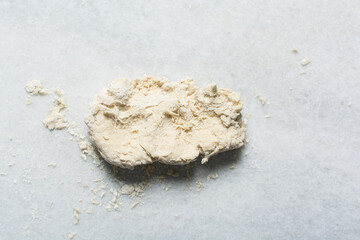 Overhead view of steamed bun dough being kneaded, top view of mantou dough being mixed, process of making steamed milk buns