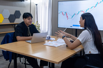 Young professionals discussing market trends in a modern office setting during the afternoon