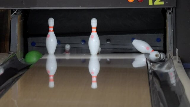 An exhilarating bowling experience with dynamic strikes and spares unfolds at a vibrant, modern alley