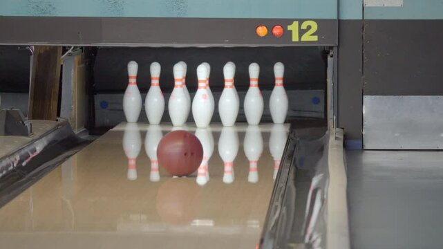 An exhilarating bowling experience with dynamic strikes and spares unfolds at a vibrant, modern alley