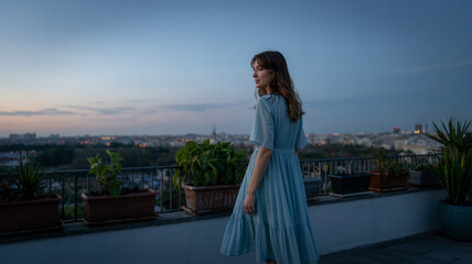 Woman stands on quiet balcony