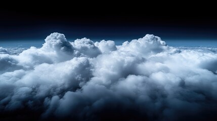 Vast, white clouds dominate the dark night sky
