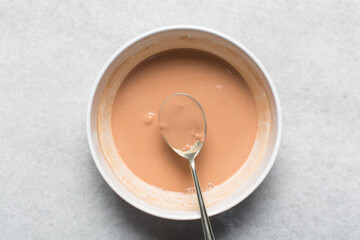 Overhead view of nigerian akamu or pap paste, process of making akamu, flatlay of process of making nigerian akamu ogi pap or guinea corn pudding