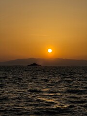 The city plunges into twilight. The sun sets between houses. Atmosphere of approaching night