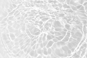 White water with ripples on the surface. Defocus blurred transparent white colored clear calm water surface texture with splashes and bubbles. Water waves with shining pattern texture background.