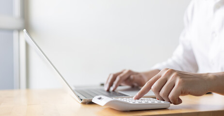 close up accountant businessman accountant hand use calculator to calculate about profit and budget on project for business and financial concept