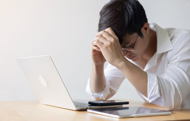 close up asian businessman hand on forehead and close eyes while feel stress and burnout and...