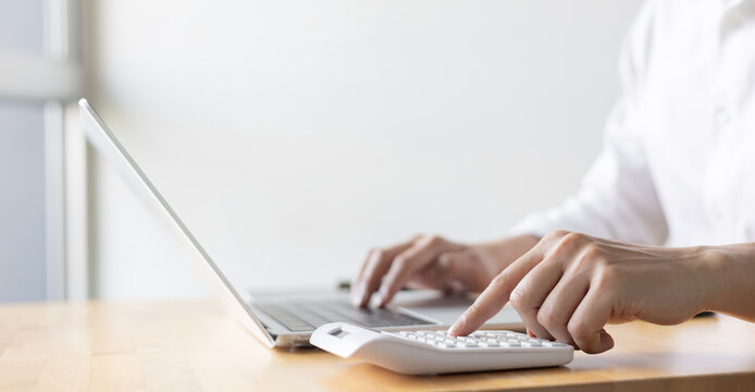 close up accountant businessman accountant hand use calculator to calculate about profit and budget on project for business and financial concept