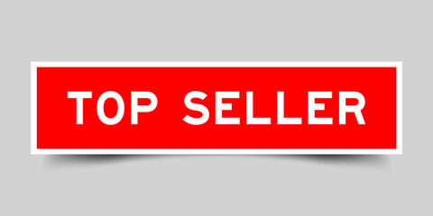Red color square shape sticker label with word top seller on gray background