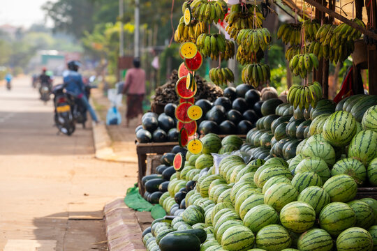 A street stall selling fruits and vegetables, mainly watermelons and bananas of different kinds in Pakse, Laos