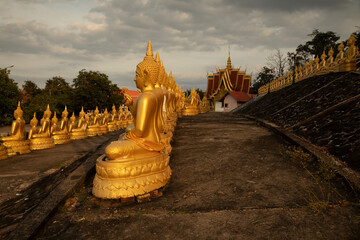 Golden Buddha statues, seated in different meditation positions, at the Wat Phousalao temple, near...