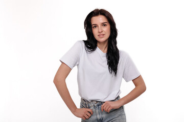 Fototapeta premium Young woman posing confidently in casual attire against a plain background during a photoshoot