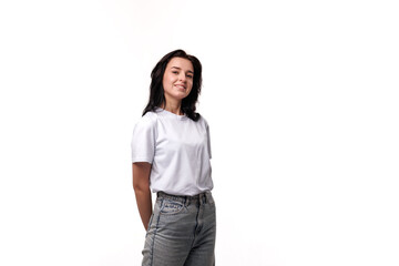 Smiling woman in casual outfit poses confidently against plain background, showcasing modern fashion style and personality